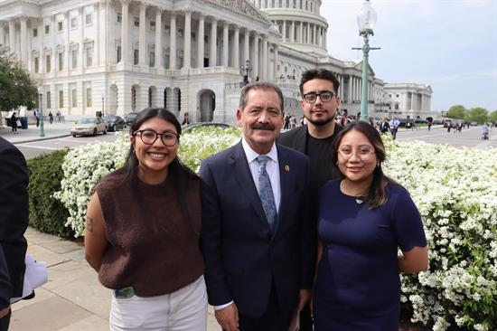 Congressman poses with press conference participants 