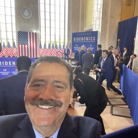 Congressman Garcia selfie with President Biden in the background