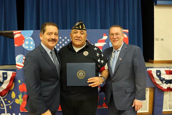 Congressman poses with commendation