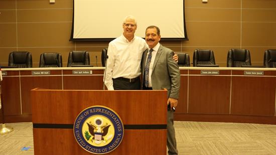 Congressman Garcia and Mayor Pedersen pose in front of a podium