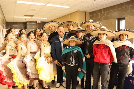 Congressman poses with a mariachi band