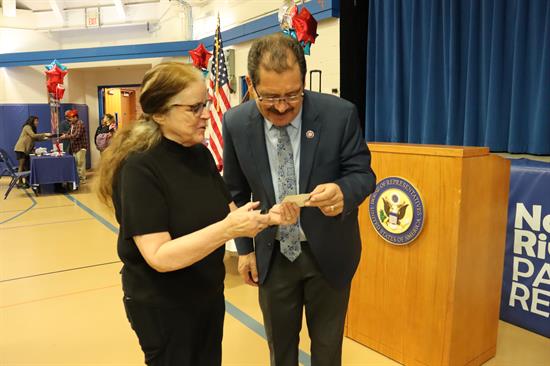 Congressman looks at an attendees photo